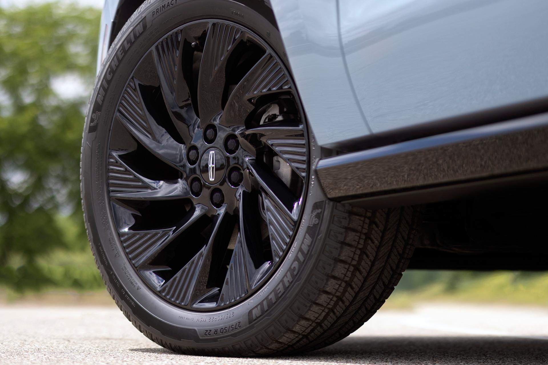 The 22" High Gloss Ebony Black Aluminum Wheel, included with available Jet Appearance Package on a 2026 Navigator® Reserve